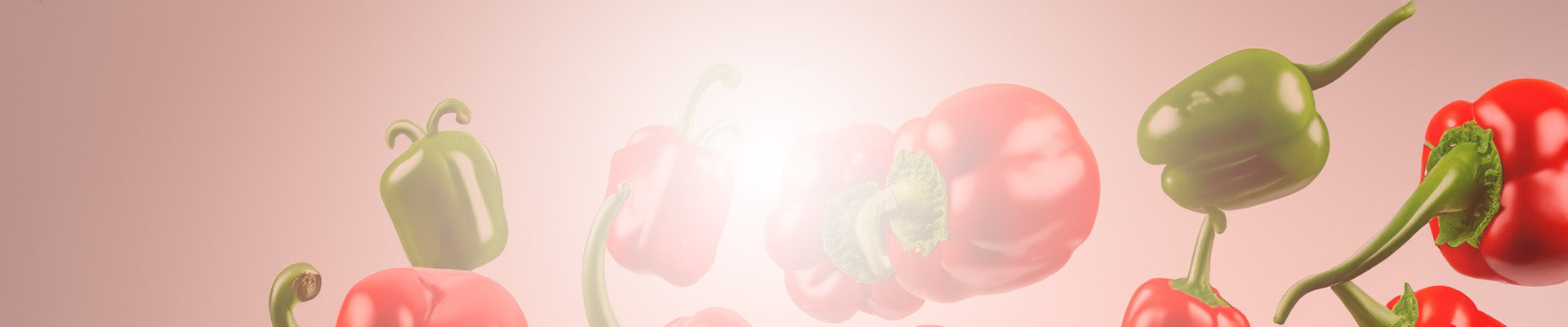 Red peppers and green peppers thrown in the air