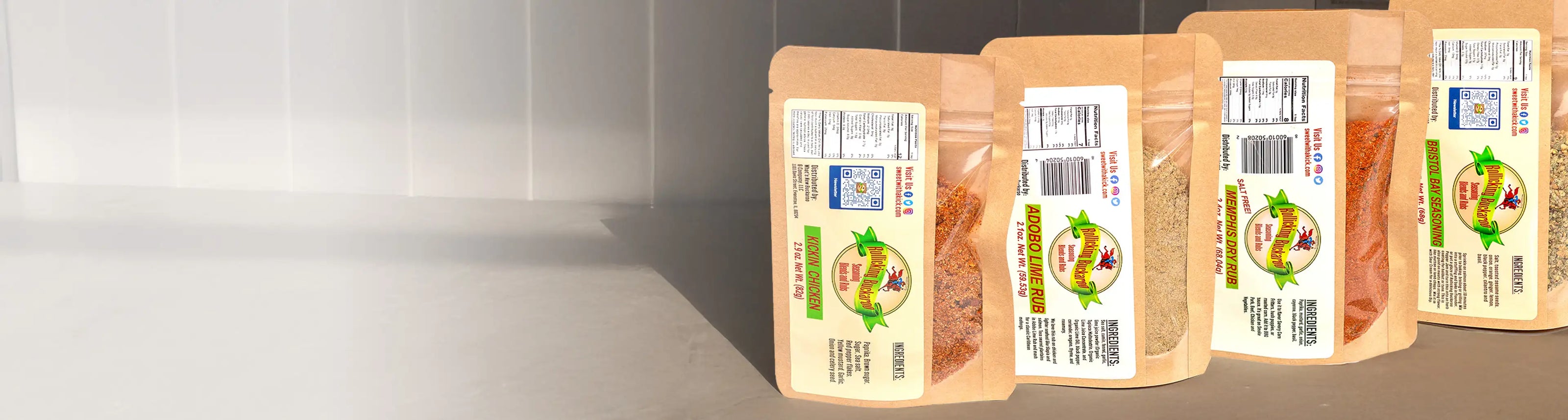 Rollicking Buckaroo Kicking Chicken, Adobe Lime Rub, Memphis Dry Rub, and Bristol Bay Seasoning Blends next to each other on a kitchen counter top