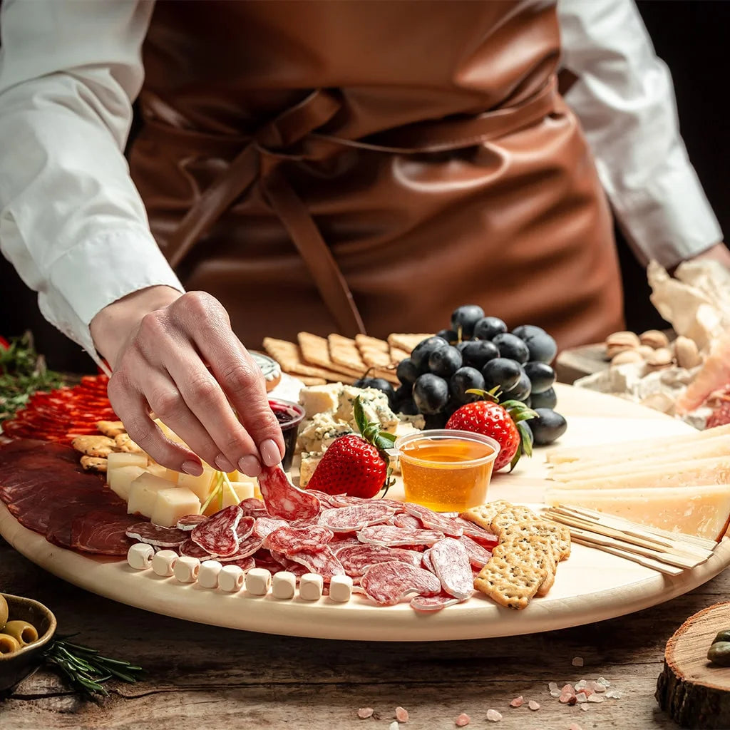 chef placing meat on a charcuterie board